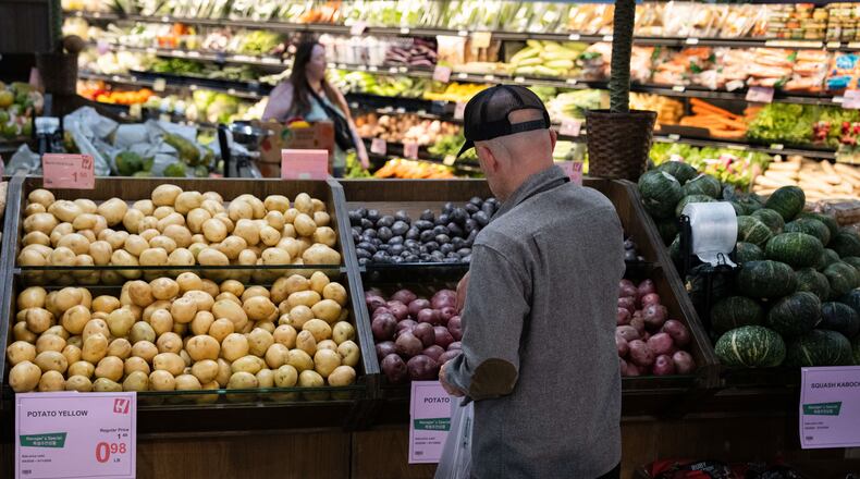 Customers shop in the produce section of a grocery store on Monday, May 11, 2026, in Portland, Ore. (AP Photo/Jenny Kane)