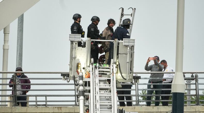 Emergency personnel remove Guido Reichstadter, 45, off the Frederick Douglass Bridge, Wednesday, May 6, 2026 in Washington. Reichstadter, who scaled to the top of the Frederick Douglass Bridge in Washington last week, has come down, after his 6-day protest. (AP Photo/Julia Demaree-Nikhinson)