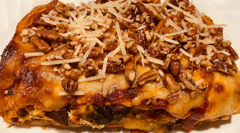 Chicken lasagna Florentine is topped with Parmesan cheese and chopped pecans. Bob Townsend for The Atlanta Journal-Constitution