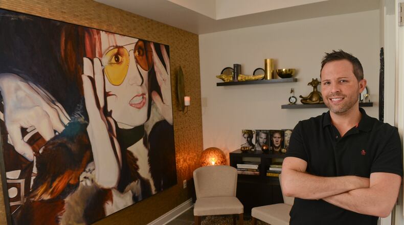 Homeowner Jordan McAuley, an author and entrepreneurs hangs out often with friends in the lounge space he created in his Midtown Atlanta condo, which has 1,432 square feet. He purchased the two-bedroom, two-bath condo in 2013 and worked with designer Krystee Manifold Spencer on Gidding&Spencer on features such as the wallcoverings. (Christopher Oquendo Photography/www.christopheroquendophotography.com)