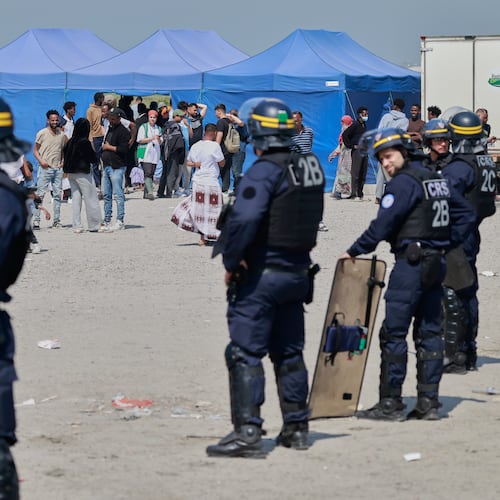 Police conduct a search operation at a makeshift camp of migrants who want to cross the English Channel to Britain near Dunkirk, northern France, Wednesday, May 27, 2026. (AP Photo/Jean-Francois Badias)