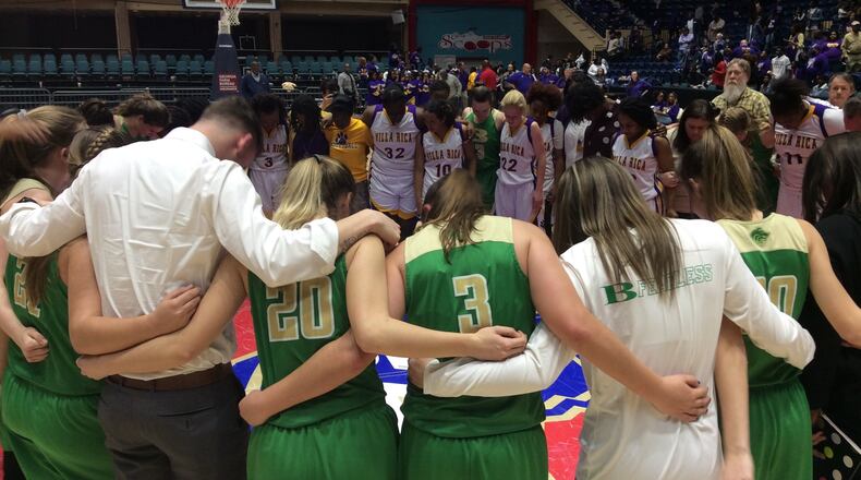 Players from Buford and Villa Rica share a moment on the court together after Buford's 67-59 victory in the Class AAAAA girls basketball state championship game Friday at the Macon Coliseum.