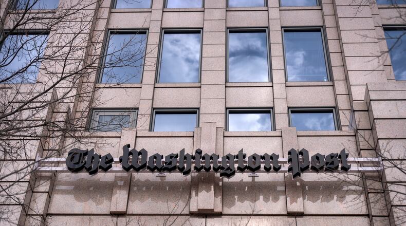 A sign for the Washington Post is seen at the company's offices, Monday, Jan. 26, 2026, in Washington. (AP Photo/Mark Schiefelbein)