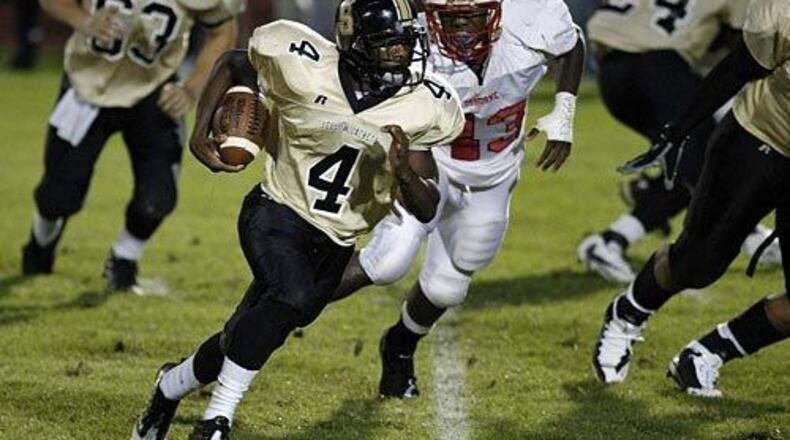 Sprayberry quarterback Jerick McKinnon (4) finds some running room behind his offensive line as Osborne defender Chaun McKinley (43) pursues. (Curtis Compton/AJC file)
