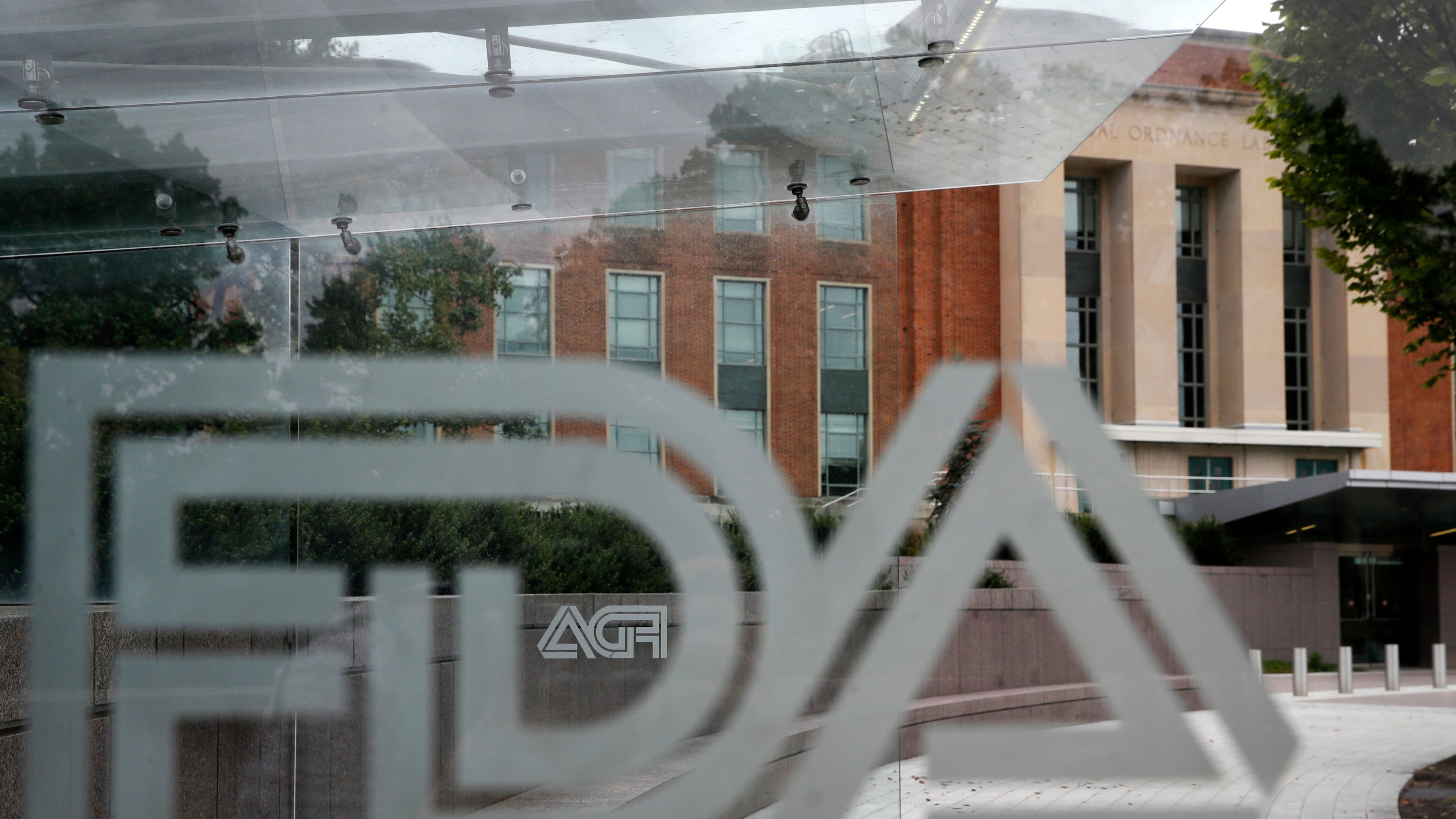 FILE - The U.S. Food and Drug Administration building is seen behind FDA logos at a bus stop on the agency's campus in Silver Spring, Md., Aug. 2, 2018. (AP Photo/Jacquelyn Martin, File)