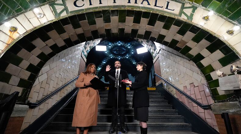 FILE - New York Attorney General Letitia James, left, administers the oath of office to mayor-elect Zohran Mamdani, center, as his wife Rama Duwaji looks on, Jan. 1, 2026, in New York. (AP Photo/Yuki Iwamura, File)