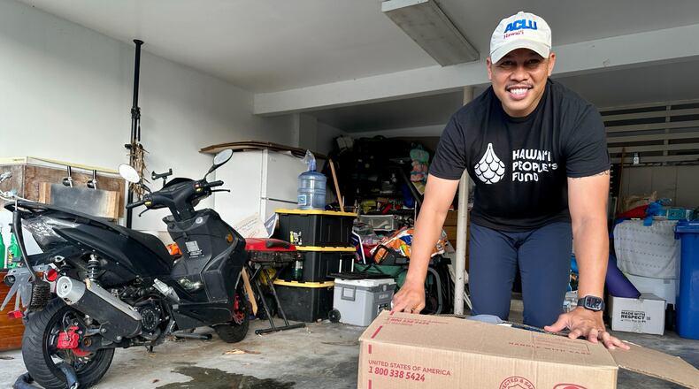 Sergio Alcubilla stands with a balikbayan box he sealed in Honolulu, on Monday, May 11, 2026. (AP Photo/Jennifer Sinco Kelleher)