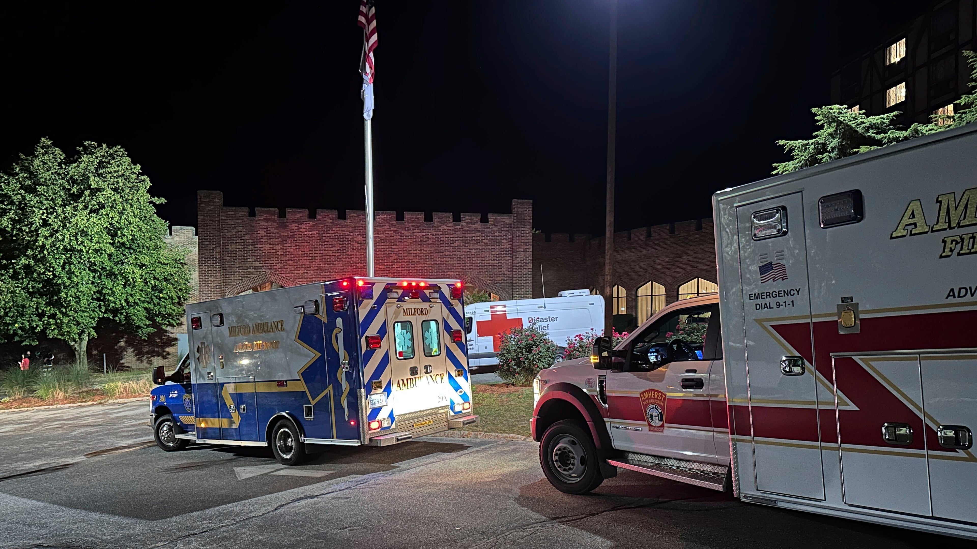 Ambulances are parked outside a hotel that is acting as a reunification center after a shooting at a country club in Nashua, New Hampshire, Saturday, Sept. 20, 2025. (AP Photo/Michael Casey)