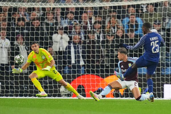 PSG's Nuno Mendes, right, scores his side's second goal during the Champions League quarterfinal second leg soccer match between Aston Villa and Paris Saint-Germain at Villa Park stadium, Birmingham, England, Tuesday, April 15, 2025. (AP Photo/Kirsty Wigglesworth)