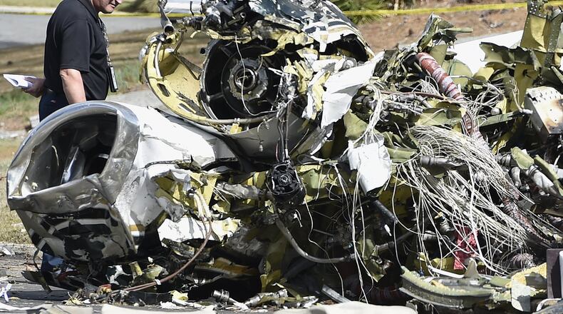 A Cessna Citation I, crashed into a suburban Marietta neighborhood Friday evening, killing the pilot and setting a house ablaze, officials said. Investigators have not released the name of the pilot killed. The homeowners, Norm and Barbara Keller, were at church when the plane crashed. (AP Photo/Mike Stewart)