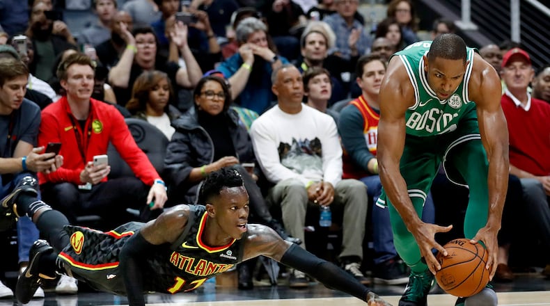 Atlanta Hawks' Dennis Schroder, left, of Germany, dives for the ball as Boston Celtics' Al Horford picks it up to shoot in the final seconds of the second quarter of an NBA basketball game in Atlanta, Saturday, Nov. 18, 2017. (AP Photo/David Goldman)