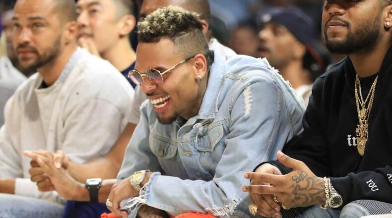 Recording artist Chris Brown attends a basketball game at Staples Center on August 13, 2017 in Los Angeles, California. Brown is another artists a women’s group wants Spotify to ban after the music streaming service banned R. Kelly songs from its playlists recently.