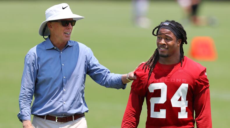 Falcons President and CEO Rich McKay gives running back Devonta Freeman a pat on the back. Curtis Compton/ccompton@ajc.com