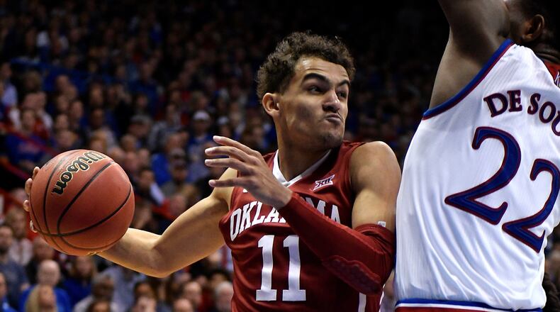 Trae Young of the Oklahoma Sooners looks to pass the ball against Silvio De Sousa of the Kansas Jayhawks in the second half at Allen Fieldhouse on February 19, 2018 in Lawrence, Kansas. (Photo by Ed Zurga/Getty Images)