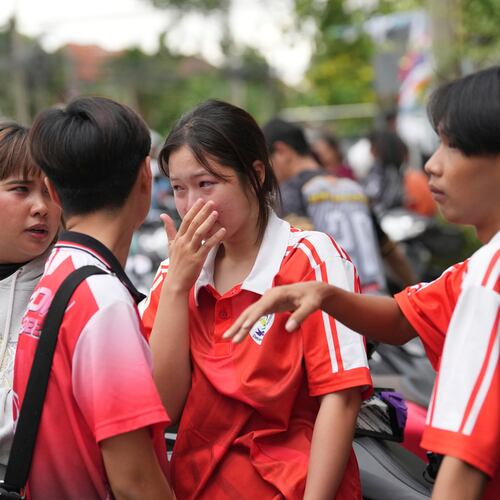 A schoolgirl cries outside her school where deaths and injuries were reported after a shooting in Thailand's Nonthaburi province, Friday, Aug. 7, 2026. (AP Photo/Sakchai Lalit)