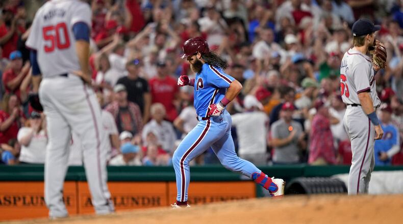 Philadelphia Phillies' Brandon Marsh, center, rounds the bases after hitting a three-run home run against Atlanta Braves pitcher Charlie Morton during the sixth inning of a baseball game, Thursday, Aug. 29, 2024, in Philadelphia. (AP Photo/Matt Slocum)