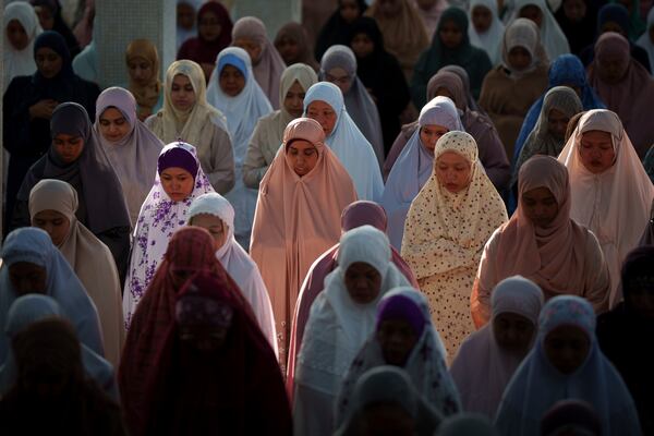 People attend prayer at National Mosque for the Eid al-Fitr, marking the end the holy fasting month of Ramadan in Kuala Lumpur, Malaysia, Monday, March 31, 2025. (AP Photo/Vincent Thian)