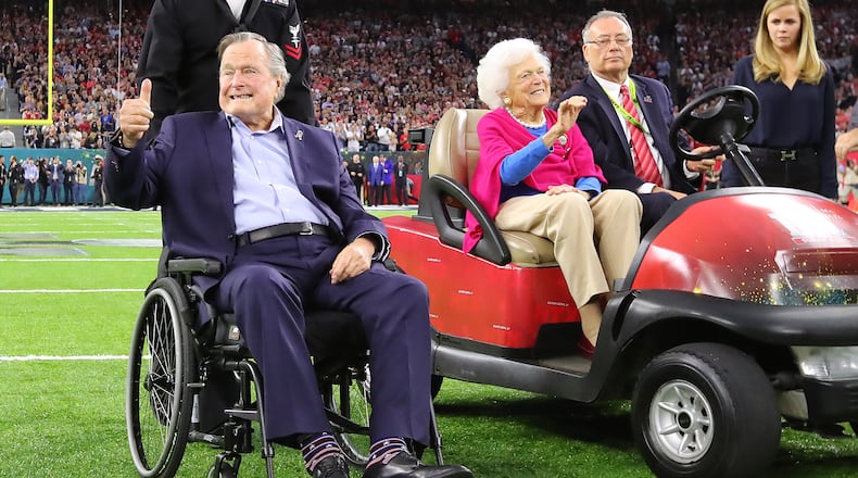 FEBRUARY 5, 2017 HOUSTON TX Former President George H.W. Bush gives the cheering crowd a thumbs up and former First Lady Barbara Bush waves as they take the field for the coin toss while the Atlanta Falcons meet the New England Patriots in Super Bowl LI at NRG Stadium in Houston, TX, Sunday, February 5, 2017. Curtis Compton/AJC