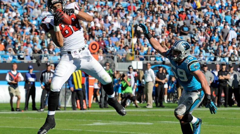 Atlanta Falcons' Tony Gonzalez (88) catches a touchdown pass as Carolina Panthers' Luke Kuechly (59) defends in the first half of an NFL football game in Charlotte, N.C., Sunday, Nov. 3, 2013. (AP Photo/Mike McCarn)