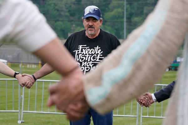 FILE - Dr. Kevin Riggs of Franklin Community Church prays with a group of capital punishment protesters on the grounds of Riverbend Maximum Security Institution before the scheduled execution of inmate Oscar Smith, April 21, 2022, in Nashville, Tenn. (AP Photo/Mark Humphrey, File)