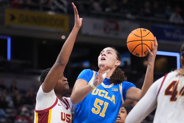 UCLA center Lauren Betts (51) shoots on Southern California center Clarice Akunwafo (34) during the second half of an NCAA college basketball game in the championship of the Big Ten Conference tournament in Indianapolis, Sunday, March 9, 2025. (AP Photo/Michael Conroy)