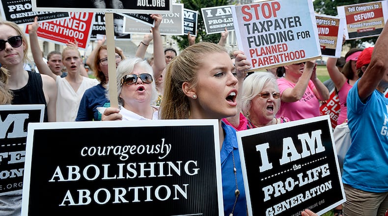 Anti-abortion activists rally against federal funding for Planned Parenthood in front of the U.S. Capitol on July 28. (Photo by Olivier Douliery/Getty Images)