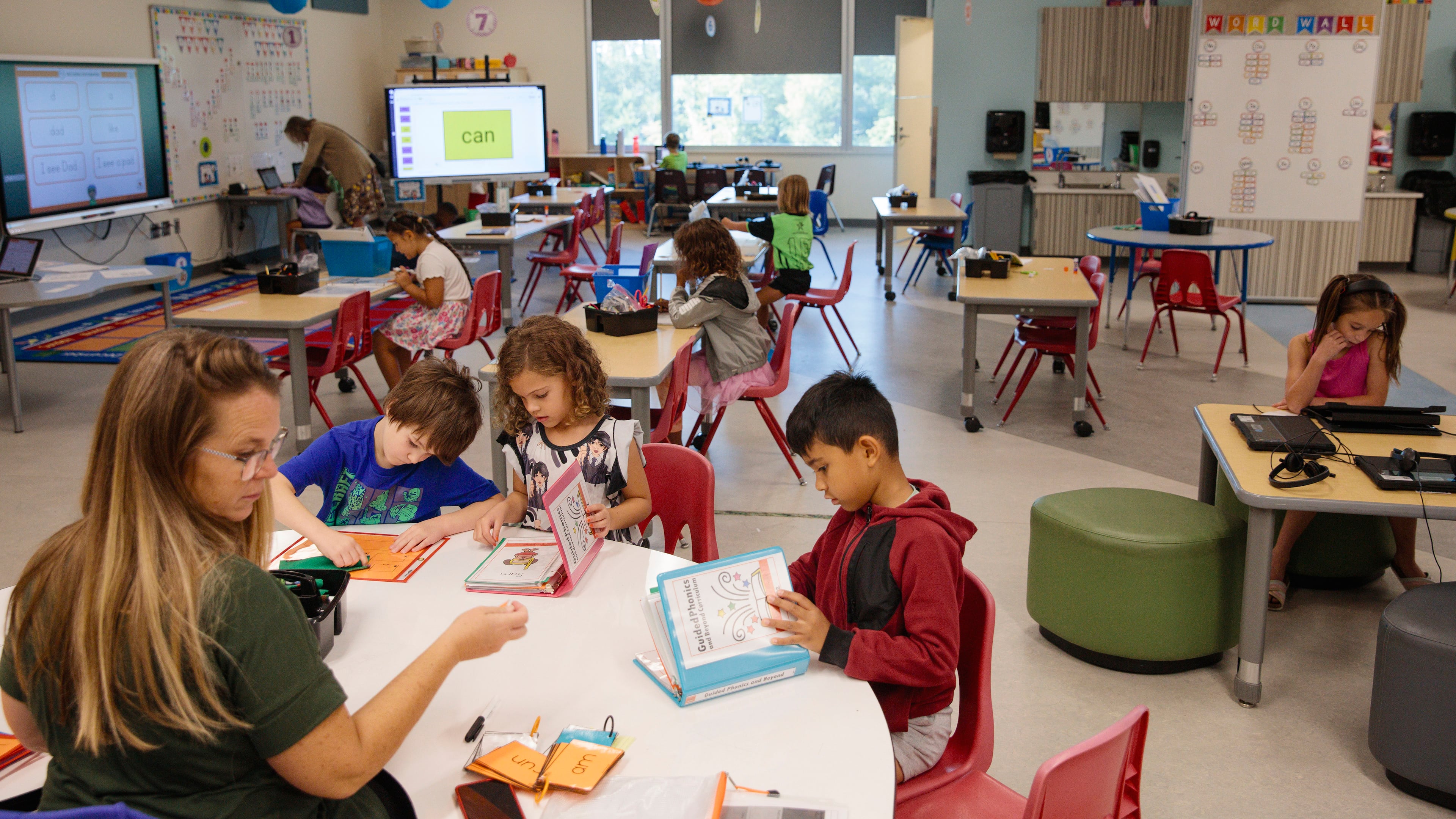 Jan Ramirez works with first-grade students at E.A. White Elementary School at Fort Moore, a major Army base on the Georgia-Alabama border, Sept. 12, 2023. With about 66,000 students, the Pentagon’s schools for children of military members and civilian employees achieve results rarely seen in public education. (Kendrick Brinson/The New York Times)