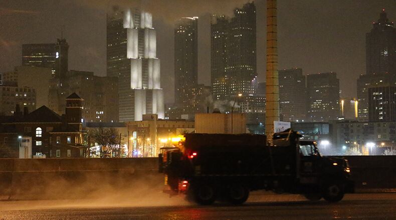 Crews were out treating the highways early Wednesday as an ice and snow storm began to coat the Atlanta region.