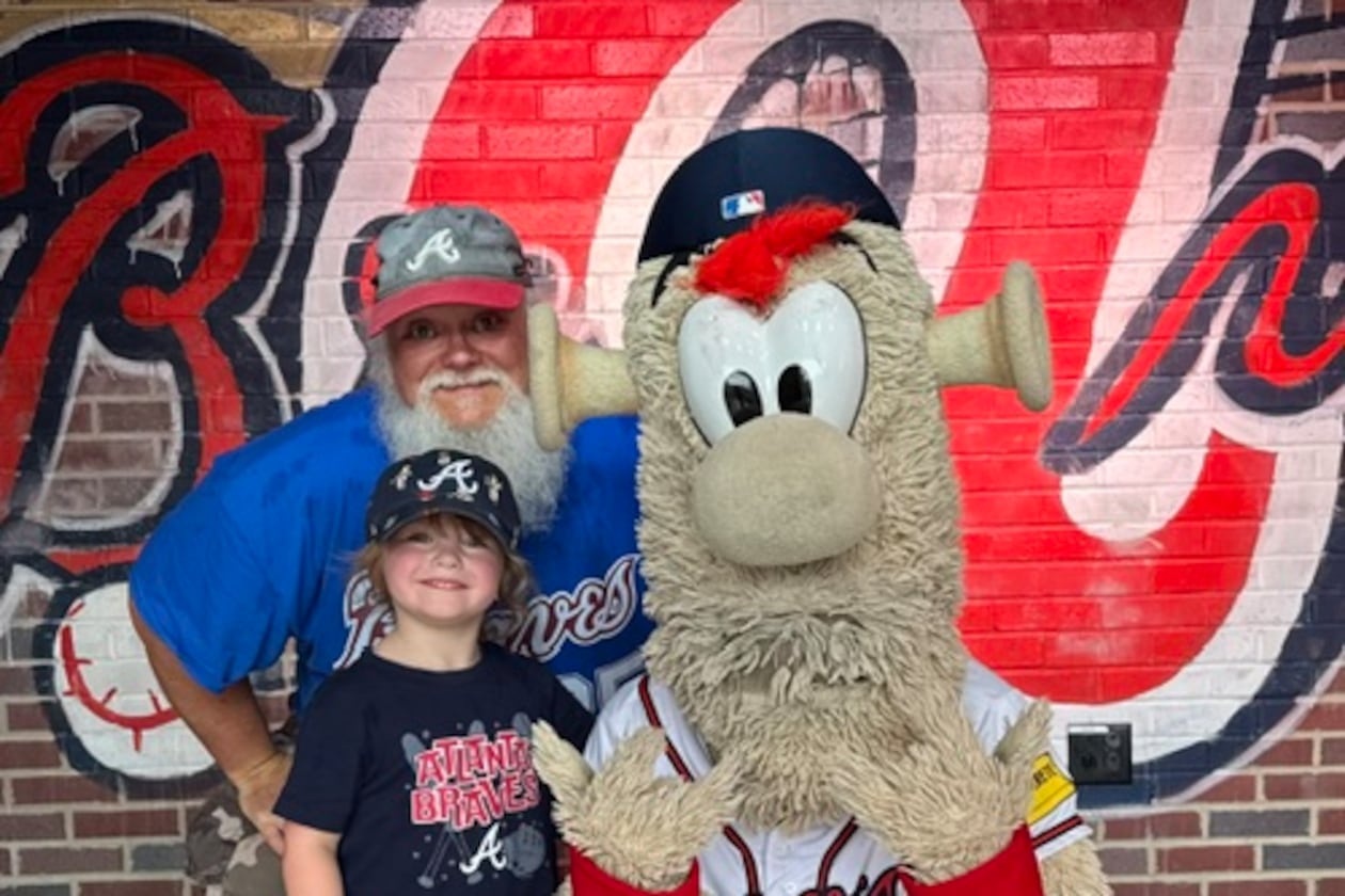 Long-time Braves fan Jimmie Boulware and his granddaughter Oakley hang out with Blooper. (Photo courtesy of Jimmie Boulware)