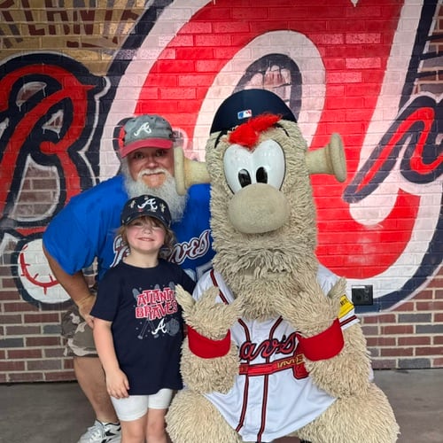 Long-time Braves fan Jimmie Boulware and his granddaughter Oakley hang out with Blooper. (Photo courtesy of Jimmie Boulware)