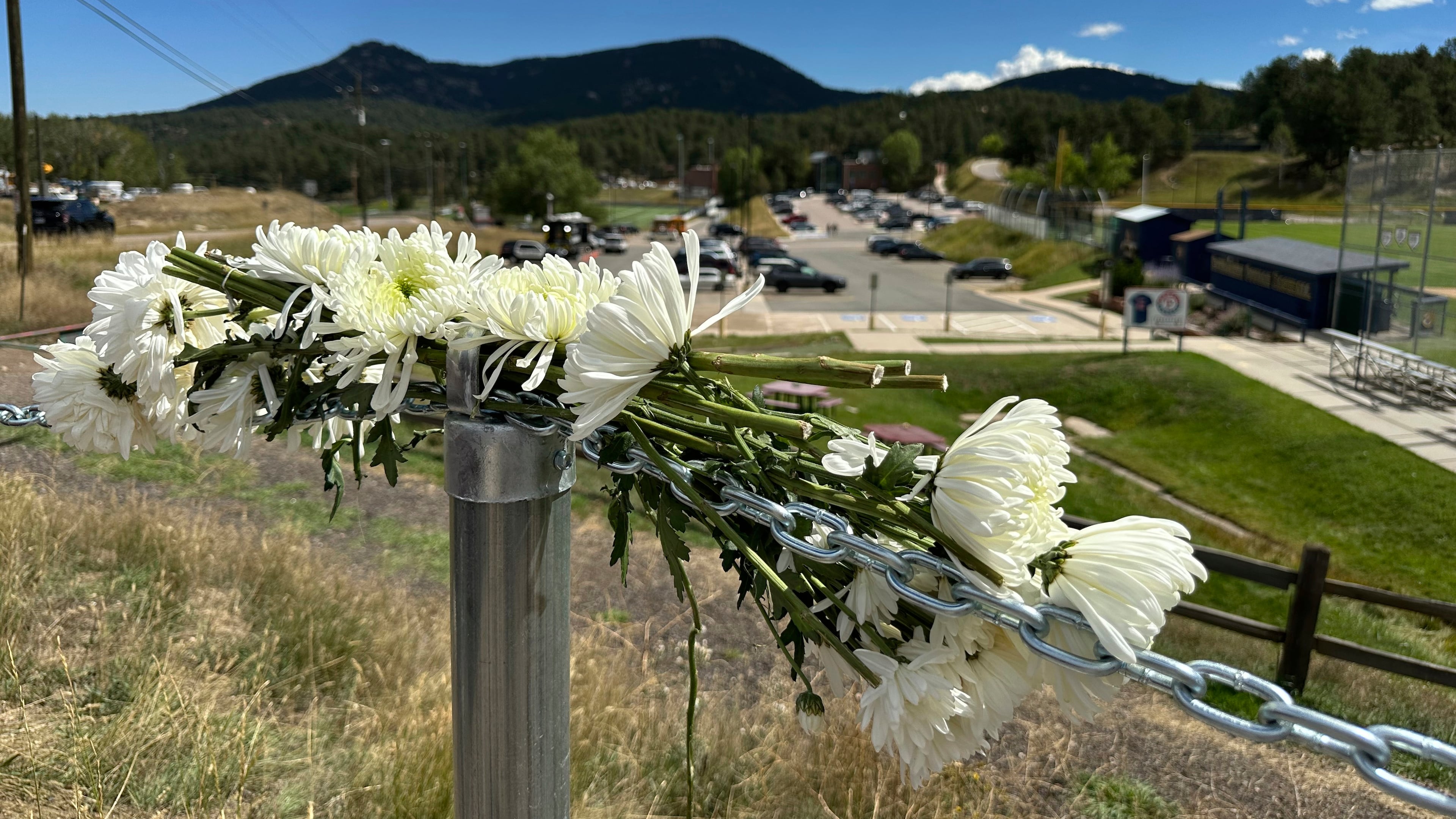Flowers are left in remembrance of those wounded in a shooting at Evergreen High School in Evergreen, Colo., Thursday, Sept. 11, 2025. (AP Photo/Colleen Slevin)