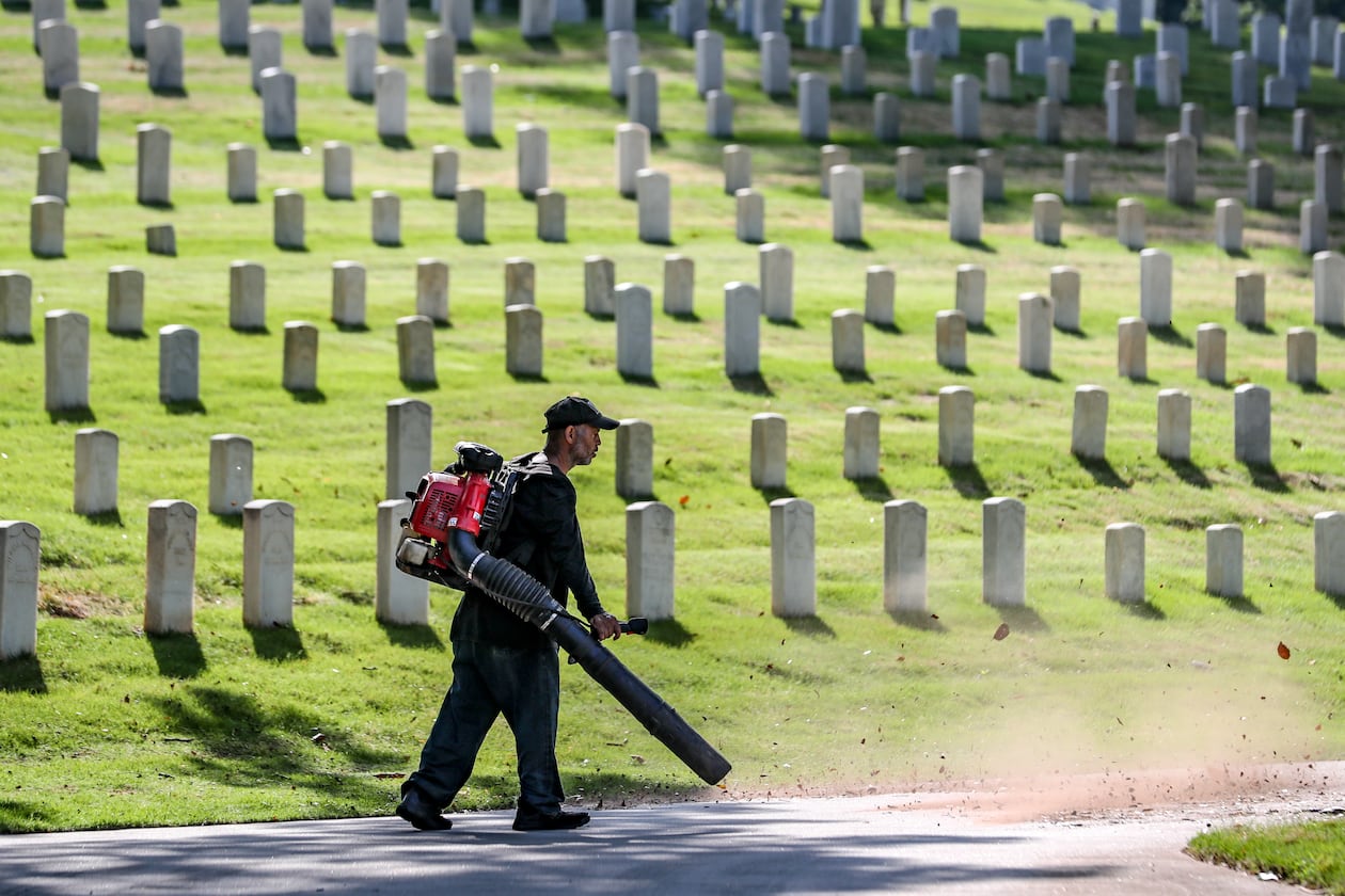 Teddy Weber spruces up the grounds of the Marietta National Cemetery on Friday, May 26, 2023, in preparation for Memorial Day weekend. Channel 2 Action News meteorologist Brian Monahan said that for Memorial Day it’ll be mostly sunny with the projected high will be in the upper 70s. (Photo: John Spink / John.Spink@ajc.com)