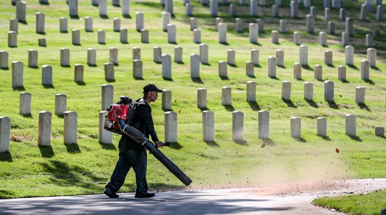 Teddy Weber spruces up the grounds of the Marietta National Cemetery on Friday, May 26, 2023, in preparation for Memorial Day weekend. Channel 2 Action News meteorologist Brian Monahan said that for Memorial Day it’ll be mostly sunny with the projected high will be in the upper 70s. (Photo: John Spink / John.Spink@ajc.com)