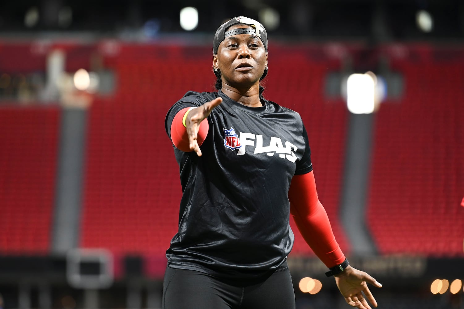 Volunteer Janitra Shields gives instructions during the 5th annual Girls Flag Football Showcase. (Daniel Varnado for the AJC)