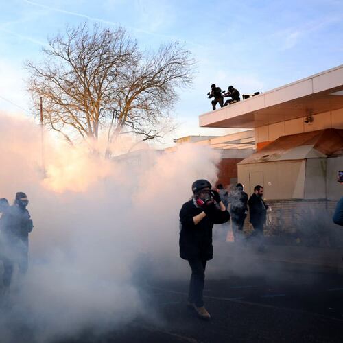 Federal agents lobbed tear gas and flash bangs at protesters in front of the ICE building on Jan. 31, 2026, in Portland, Ore. (Allison Barr/The Oregonian via AP)