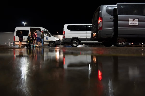 Members of Project ICECHIP gather in the Walmart parking lot to measure, weigh and crush hail during an operation late Friday, June 6, 2025, in Levelland, Texas. (AP Photo/Carolyn Kaster)