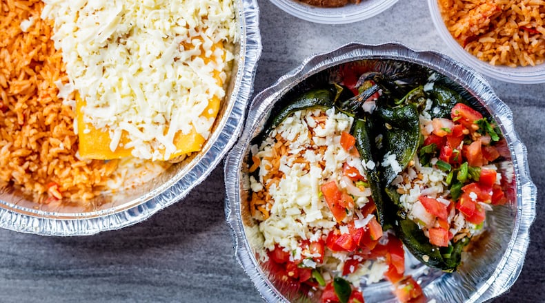 Entrees from El Ponce are prepped and ready for the oven at home, including chicken enchiladas (left) and chiles rellenos (bottom right).
