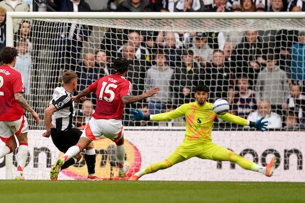 Newcastle United's Harvey Barnes, second left, scores his side's third goal during the English Premier League soccer match between Newcastle United and Manchester United in Newcastle upon Tyne, England, Sunday, April 13, 2025. (Owen Humphreys/PA via AP)