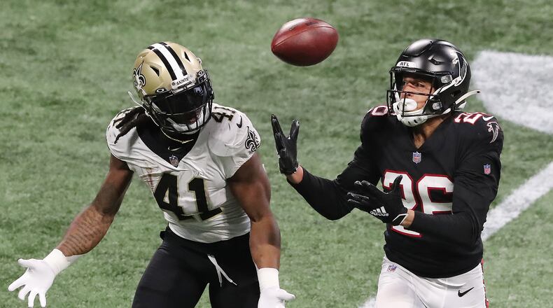 Atlanta Falcons cornerback Isaiah Oliver breaks up a pass to Saints running back Alvin Kamara but can’t come down with the interception during the fourth quarter Sunday, Dec. 6, 2020, at Mercedes-Benz Stadium in Atlanta.  (Curtis Compton / Curtis.Compton@ajc.com)