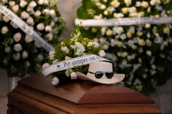 FILE - The hat and sunglasses of Dominican singer Rubby Perez, who died in the roof collapse at the Jet Set nightclub during his merengue concert, sit on his casket during his wake at the Eduardo Brito National Theater in Santo Domingo, Dominican Republic, April 10, 2025. (AP Photo/Matias Delacroix, File)