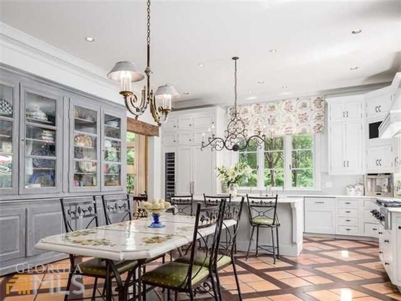 The kitchen opens to the family room, with French doors that overlook the saltwater pool.