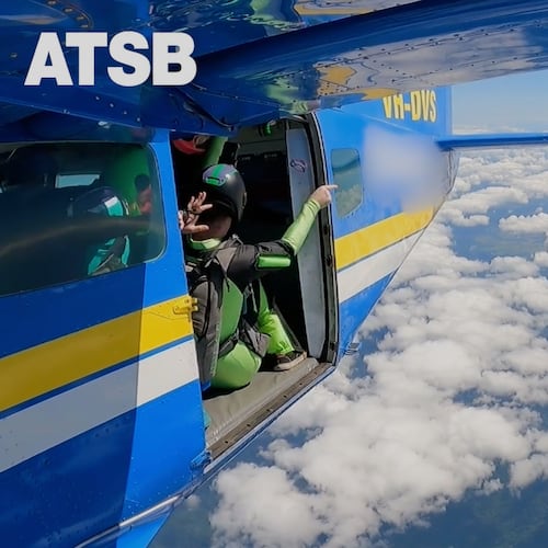In this image taken from a video a skydiver is caught on the wing of a plane as he exited the aircraft in Tully, North Queensland, Sept.20, 2025.(Jarrad Nolan/Australian Transport Safety Bureau via AP)
