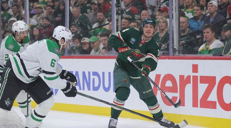 Minnesota Wild center Joel Eriksson Ek (14) passes while Dallas Stars defenseman Lian Bichsel (6) defends during the first period of Game 6 in the first round of the NHL hockey Stanley Cup playoff series Thursday, April 30, 2026, in St. Paul, Minn. (AP Photo/Bailey Hillesheim)