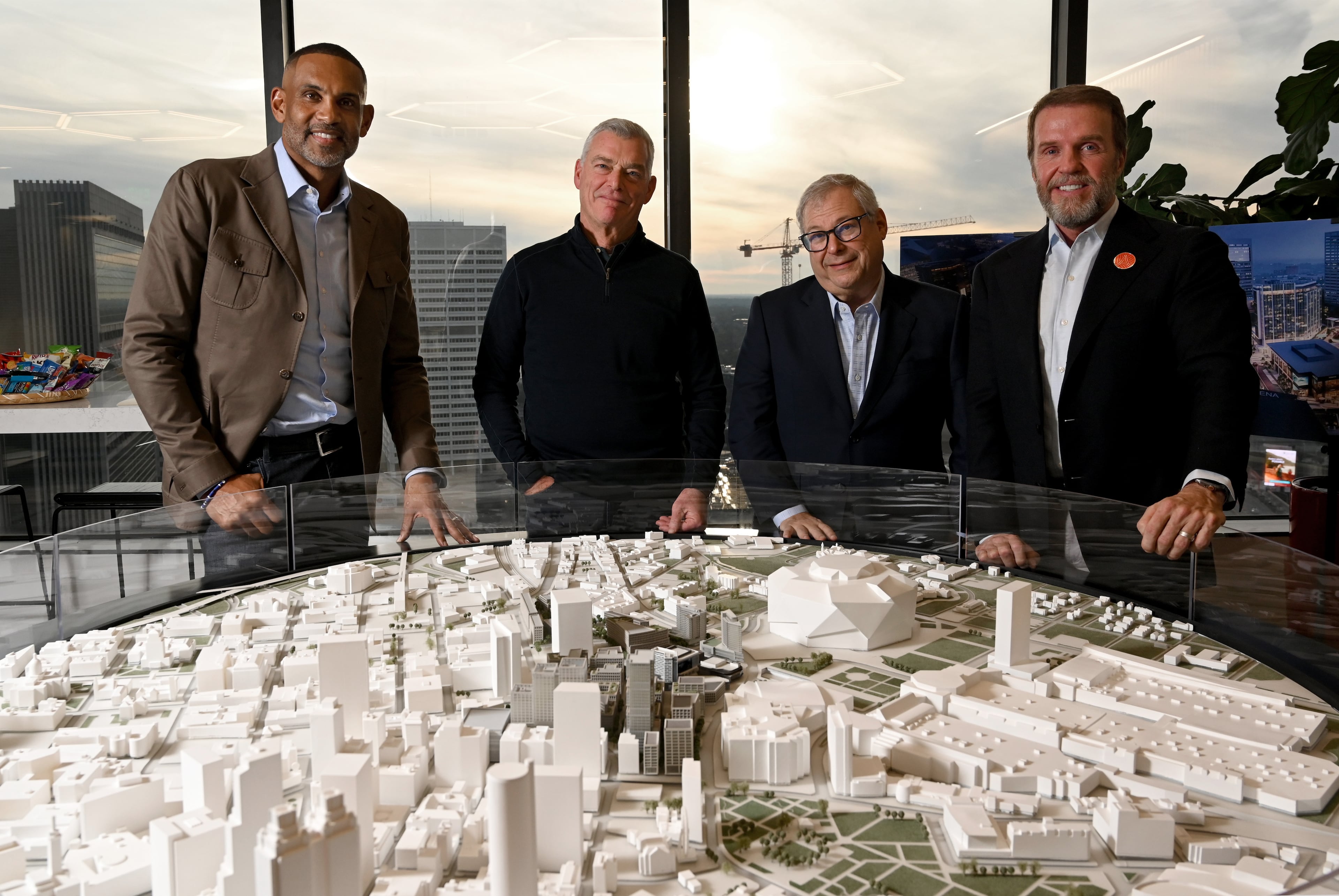 Heads of the Centennial Yards project, from left, Grant Hill, NBA Hall of Famer and co-owner of Atlanta Hawks; Tony Ressler, principal owner of Atlanta Hawks; Steve Koonin, CEO of Atlanta Hawks); and Brian McGowan, president of Centennial Yards, pose for a group photo at Centennial Yards Company, Wednesday, Dec. 3, 2025, in Atlanta. (Hyosub Shin/AJC)
