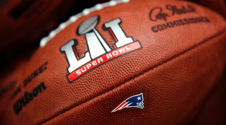 The New England Patriots' NFL Super Bowl LI game ball is finished with the team's logo affixed to it at the Wilson Sporting Goods factory Monday, Jan. 23, 2017, in Ada, Ohio.