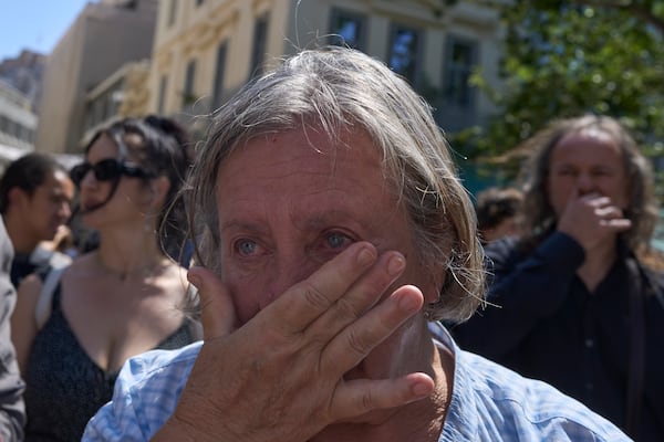 A woman weeps during a farewell ceremony for renowned clarinetist Petroloukas Chalkias, who died at 90 over the weekend, at Athens Cathedral on Wednesday, June 18, 2025. (AP Photo/Petros Giannakouris)
