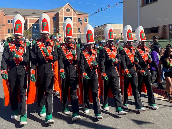 The FAMU Marching 100 drum majors have been given the name “Magnificent VII” this season. Head drum major Oluwamodupe “Dupe” Oloyede (center) is the first woman to hold the title. (Tia Mitchell/AJC)