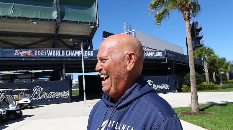 Braves manager Brian Snitker shares a laugh as he arrives for his press conference the day players have to report for spring training at CoolToday Park on Sunday, March 13, 2022, in North Port. The team’s first official workout is scheduled for Monday. “Curtis Compton / Curtis.Compton@ajc.com”`