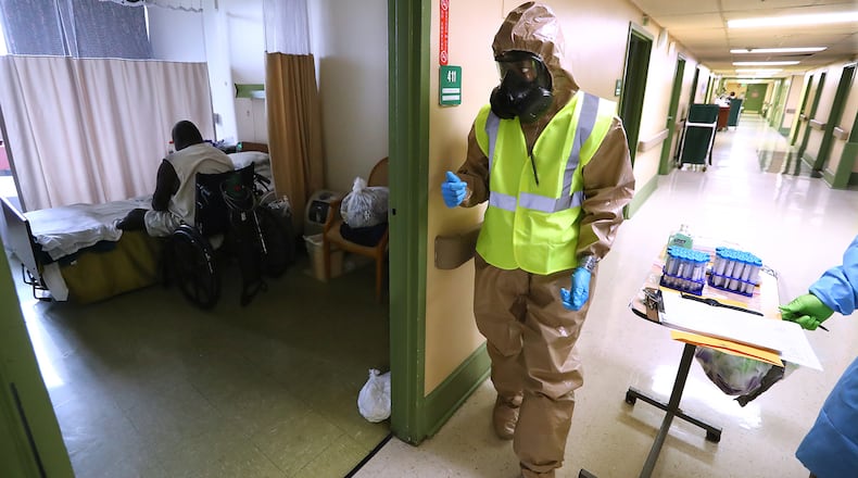 Georgia Army National Guard infection control member Pfc. Cierra Williams helps collect swabs from Legacy Transitional Care & Rehabilitation residents in April to test for the novel coronavirus, which causes COVID-19. Curtis Compton ccompton@ajc.com
