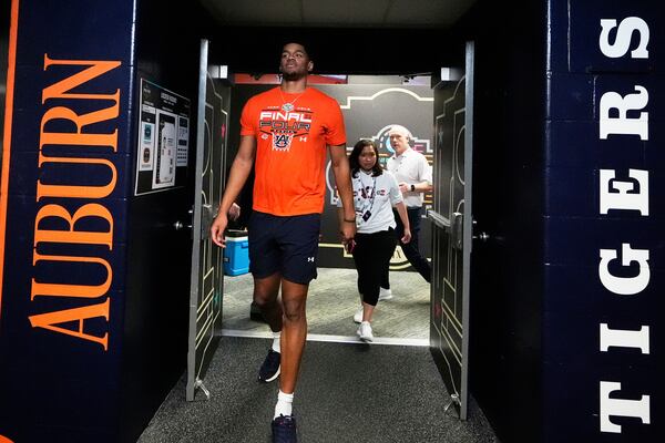 Auburn center Dylan Cardwell walks to practice during media day at the Final Four of the NCAA college basketball tournament, Thursday, April 3, 2025, in San Antonio. (AP Photo/Brynn Anderson )